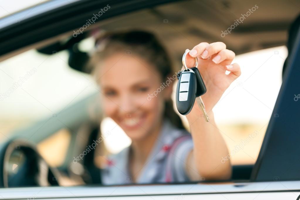 Young happy woman in car 