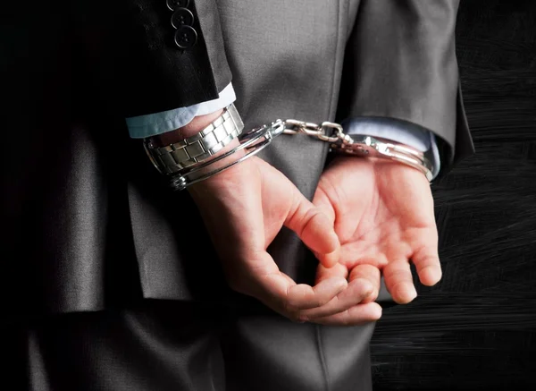 Man in handcuffs behind his back — Stock Photo, Image