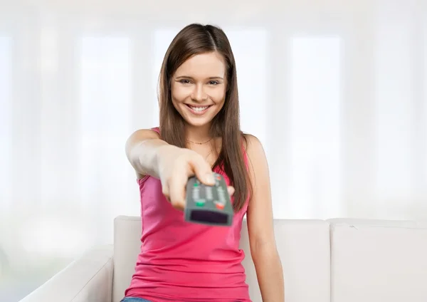 Woman with tv remote control — Stock Photo, Image