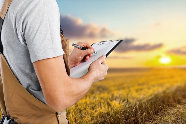 Worker writing on paperclip