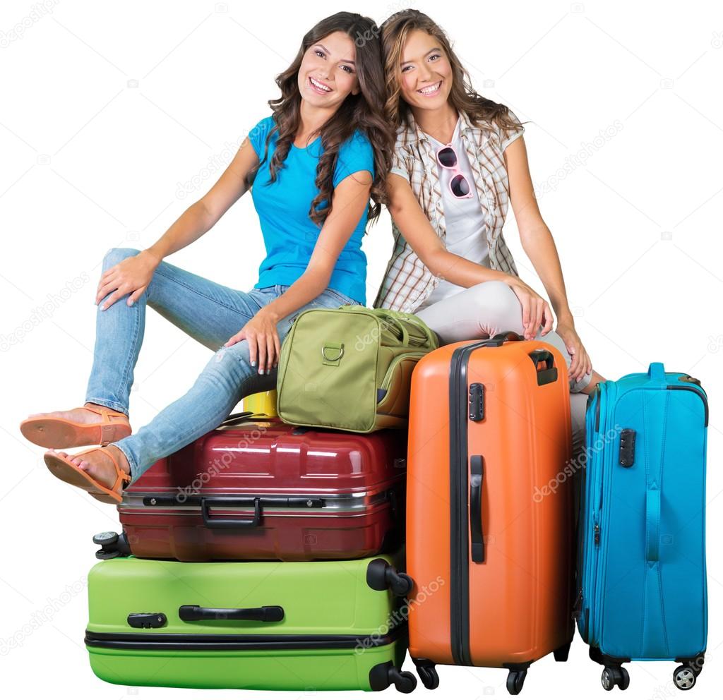  women on pile of suitcases 