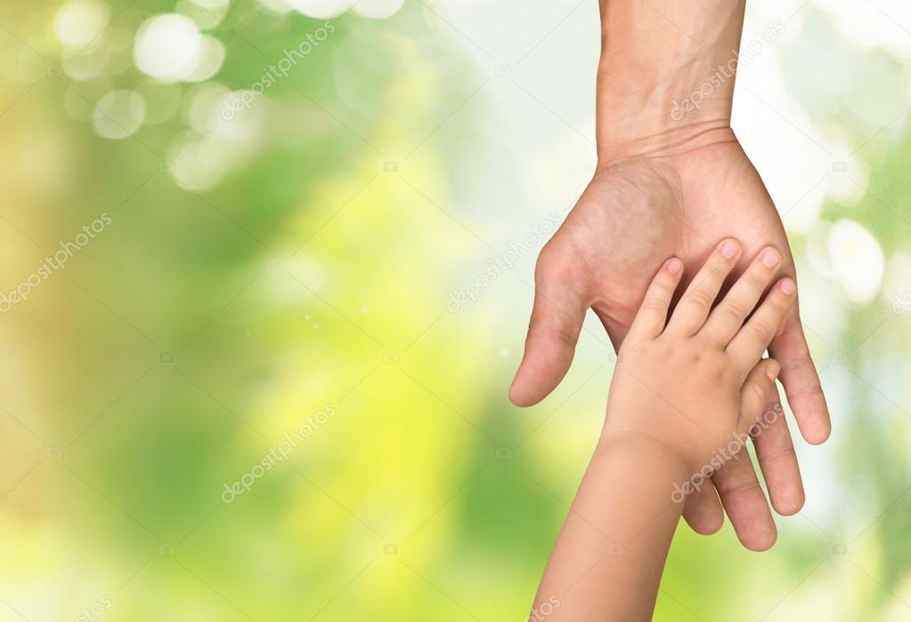 father holding baby hand