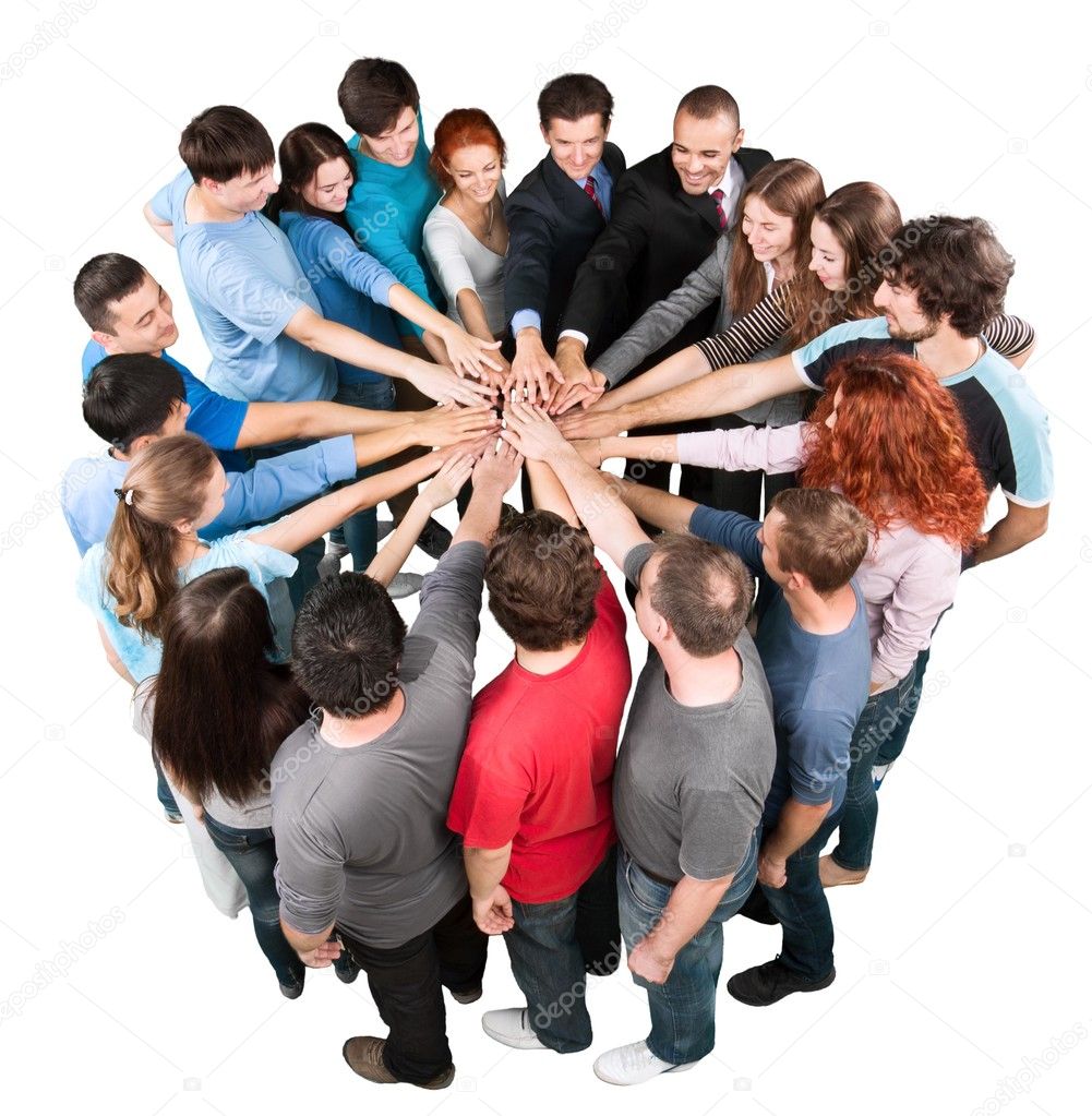 Group of smiling colleagues putting hands together, teamwork concept