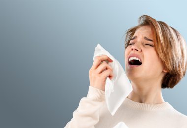  woman holding handkerchieif blowing nose clipart