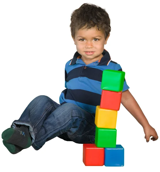 Menino sentado perto de blocos de brinquedo — Fotografia de Stock