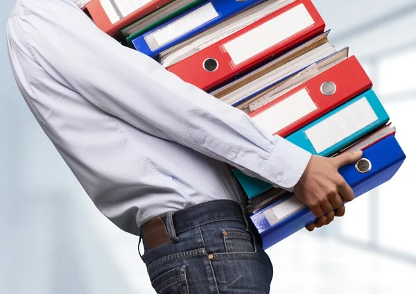 Office worker holding binders — Stock Photo, Image