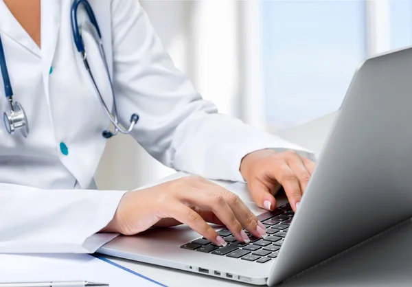 Doctor working with laptop