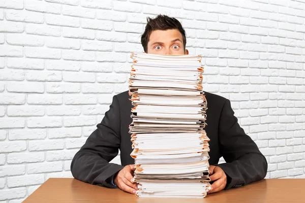 Businessman with many business papers — Stock Photo, Image