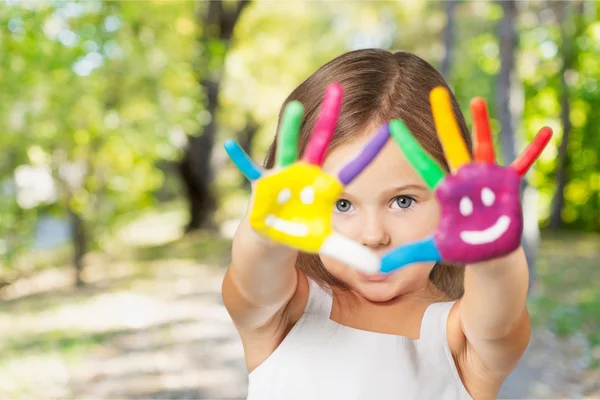 Little girl with colorful painted hands — Stock Photo, Image