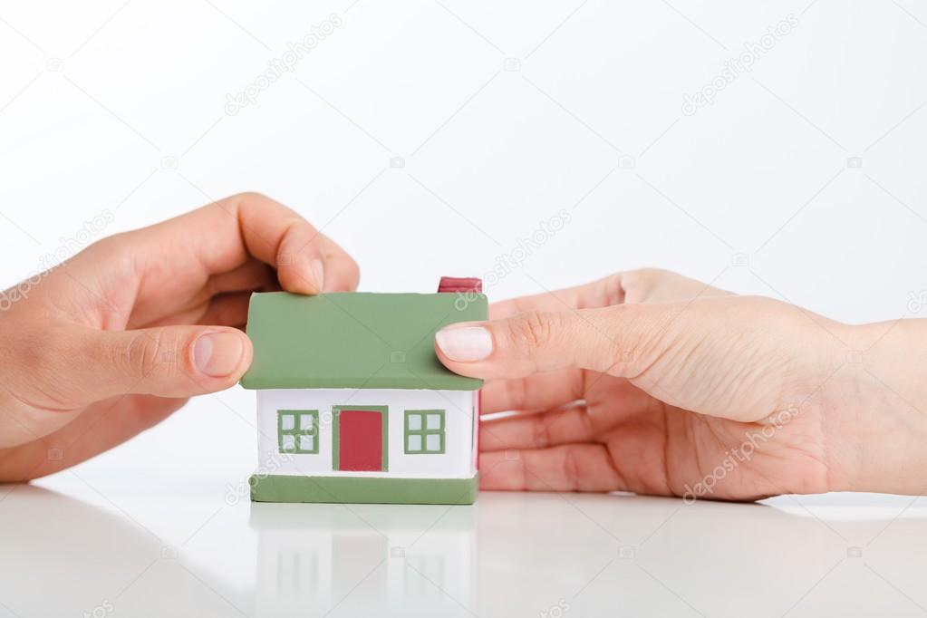 hands with house model