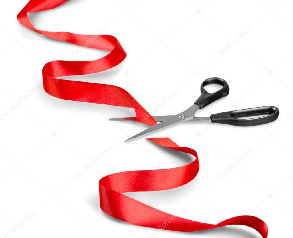 scissors and red ribbon on a white
