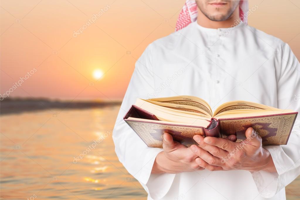 man muslim reading Quran