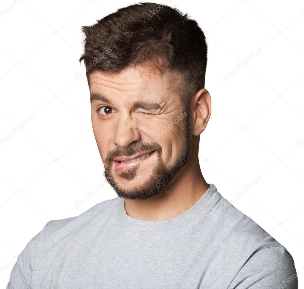 Young man winking an eye — Stock Photo © billiondigital #118554676, image size:1023x973