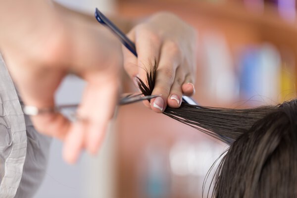 man having a haircut with scissors