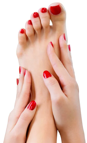 Voet met de pedicure en handen — Stockfoto