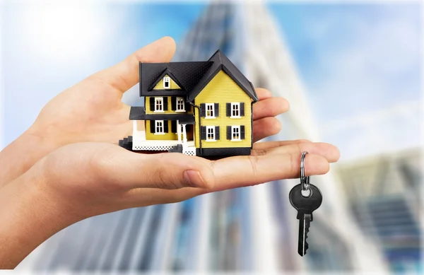 Businessman Holding House Model