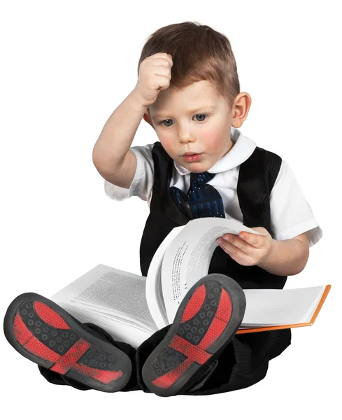 Menino segurando livro enquanto sentado — Fotografia de Stock