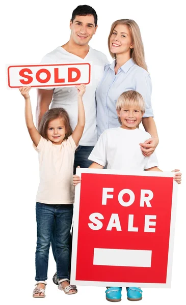 Happy Family with for sale sign — Stock Photo, Image