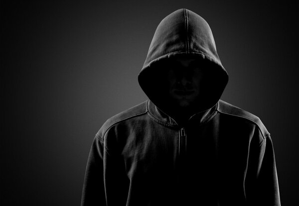 Dark unrecognisable man in hoodie