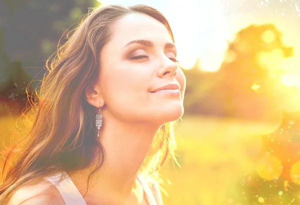 Vrouw op veld onder zonsondergang licht — Stockfoto