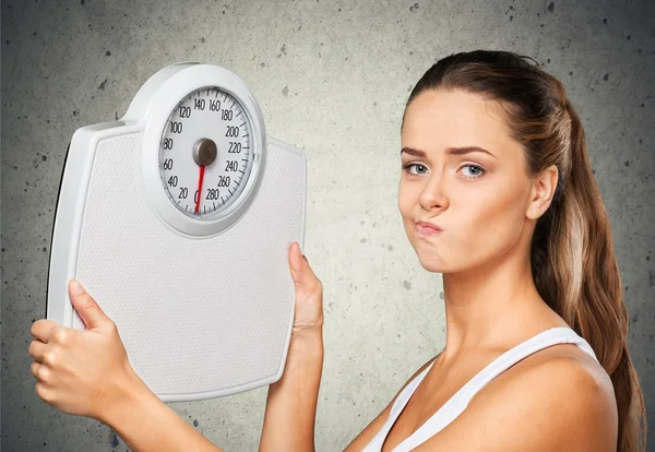 Young  woman holding scales — Stock Photo, Image