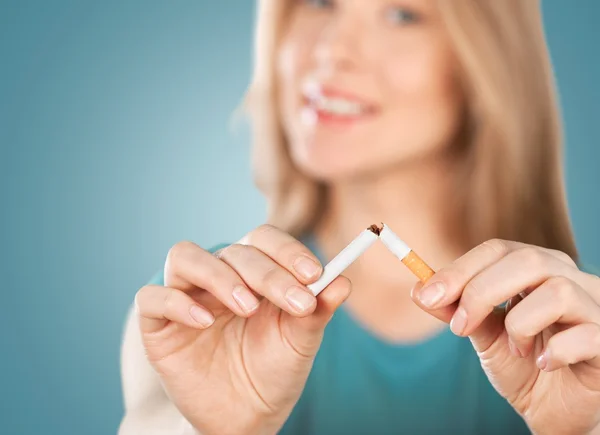 young woman breaking cigarette