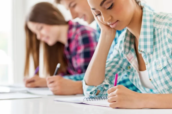 group of student writing exam test