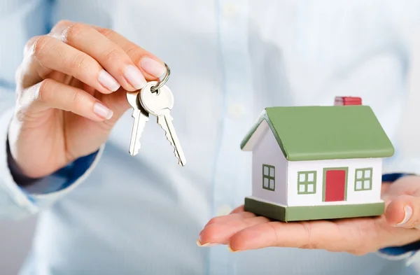 Businessman Holding House Model Stock Image