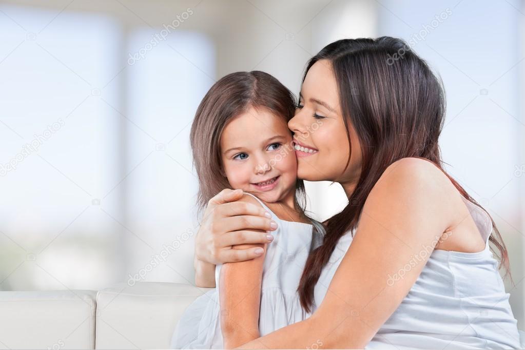 Mother and daughter hugging  