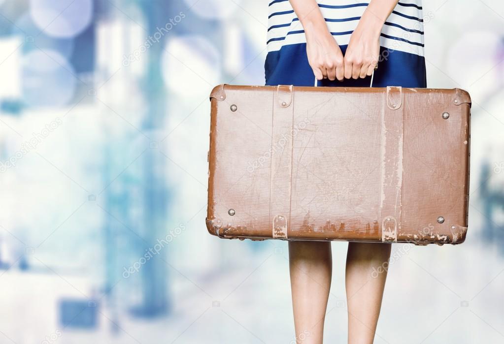 girl holding vintage suitcase