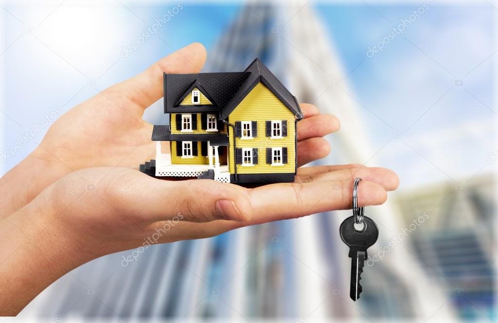 Businessman Holding House Model