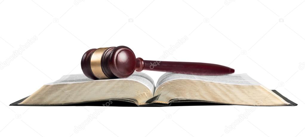 book and wooden gavel on table
