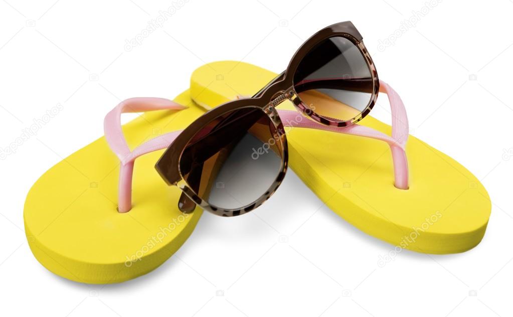 yellow flip flops and sunglasses