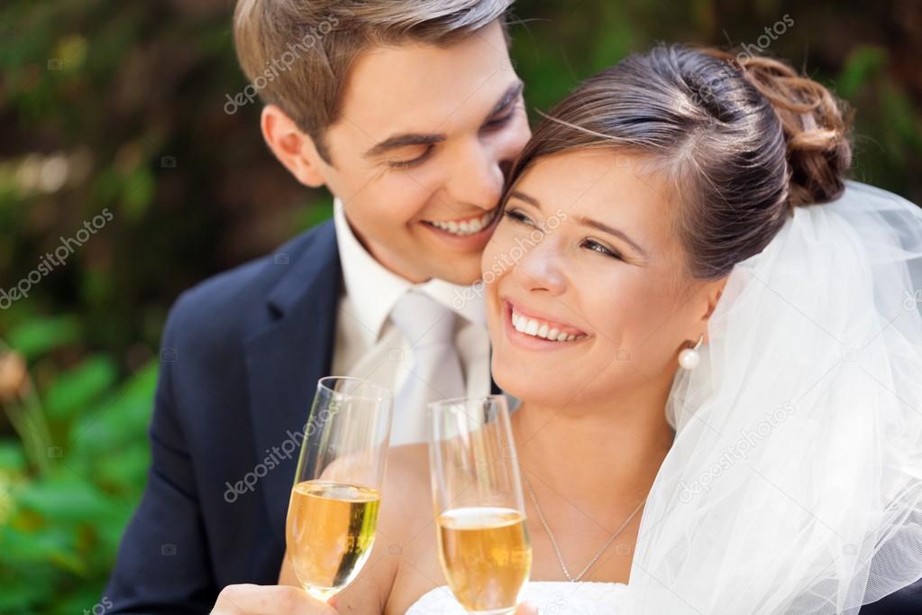 Wedding Couple Holding Champagne Glasses