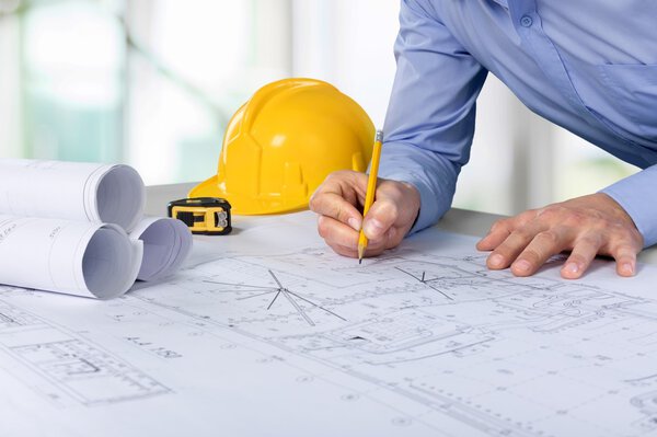 Architect working on construction blueprint