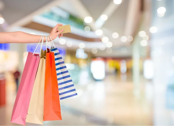 Woman hand with many shopping bags — Stock Photo, Image