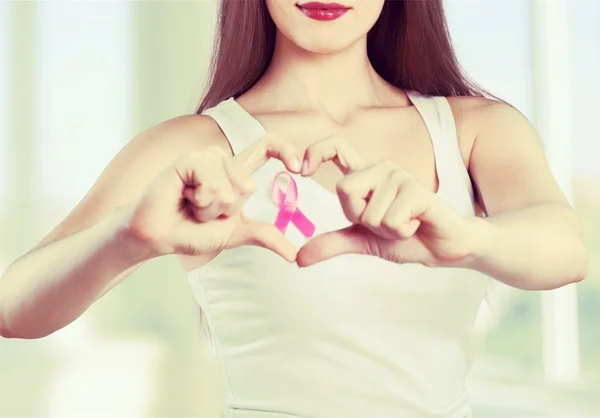 woman chest with pink badge