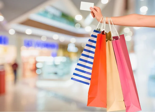 Woman with shopping bags and card — Stock Photo, Image