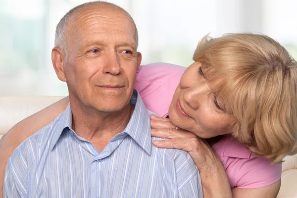 Happy senior couple smiling at home — Stock Photo, Image