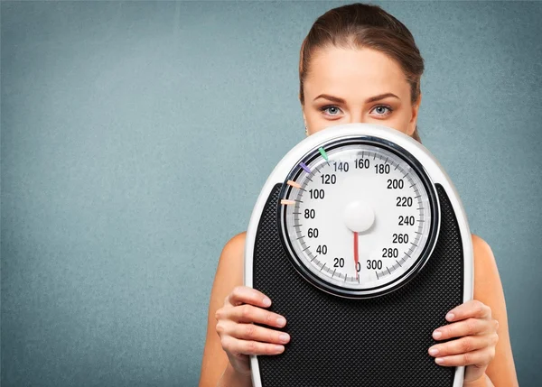 Young  woman holding scales — Stock Photo, Image