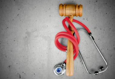 gavel and stethoscope  on background clipart