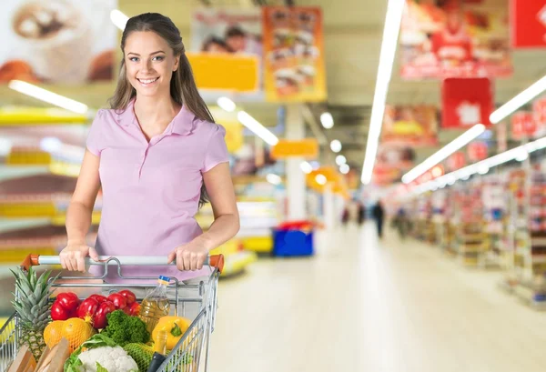 Vrouw met kar winkelen — Stockfoto