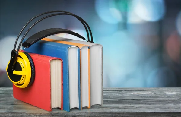 Books and headphones on background — Stock Photo, Image