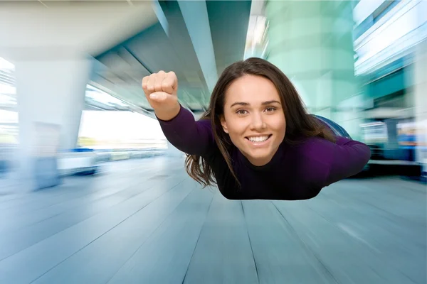 Jonge vrouw vliegen als superman — Stockfoto