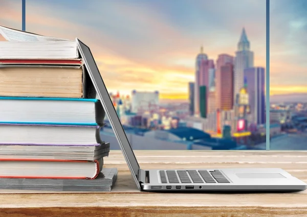 Stack of books with laptop — Stock Photo, Image