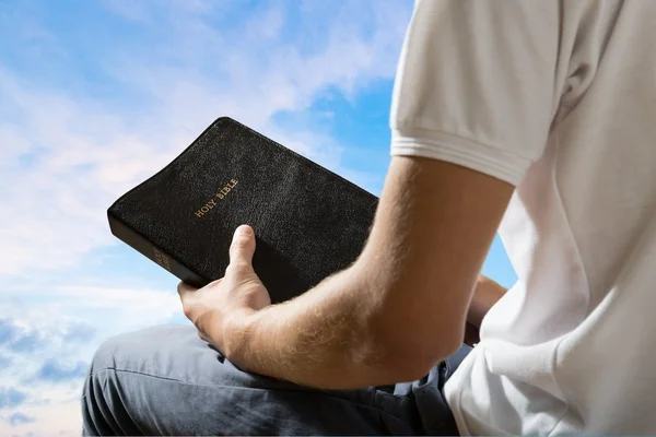 Homme tenant livre biblique — Photo