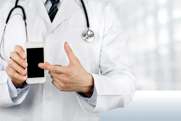 Doctor pointing at smartphone — Stock Photo, Image