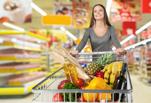 Woman with cart shopping Stock Image