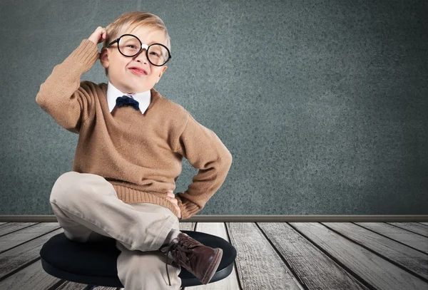 Young boy in  glasses thinking Stock Photo