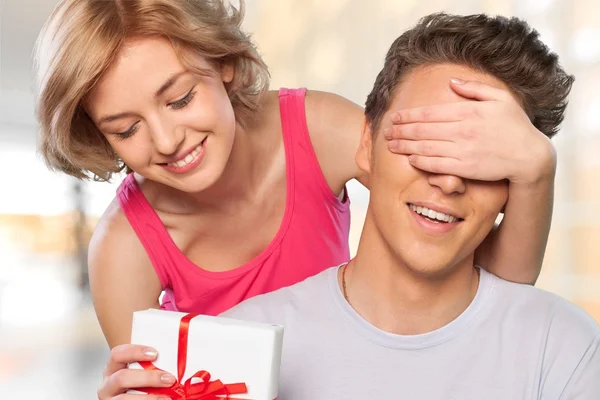 Girl covering her boyfriend's eyes Royalty Free Stock Photos